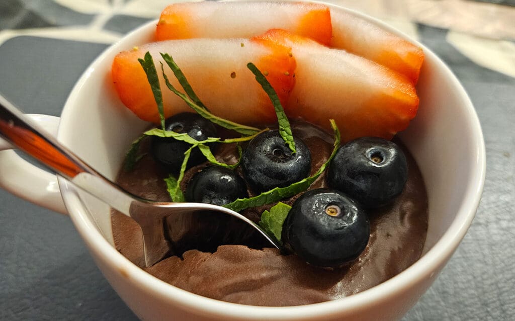 Fench Chocloate mousse with blueberries, strawberries, and shredded min leaves