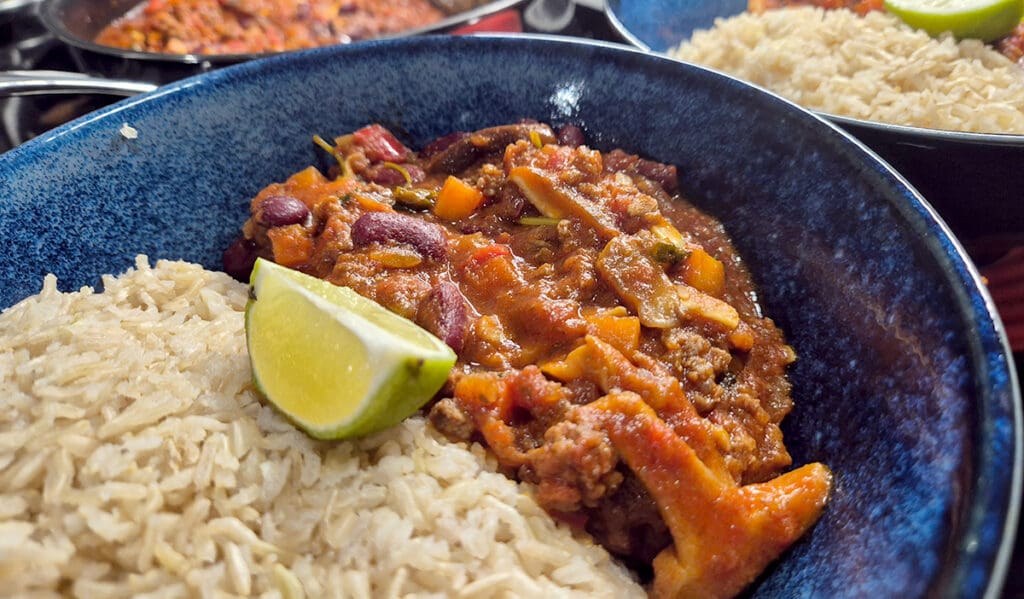 Chilli con carne with brown basmati rice and wedge of fresh lime