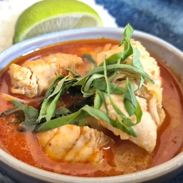 Thai Red Curry with Chicken and Pineapple, served with steamed jasmine rice and a wedge of lime.